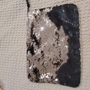 NWOT Cheekys brand color changing sequin wristlet. Changes from silver to black